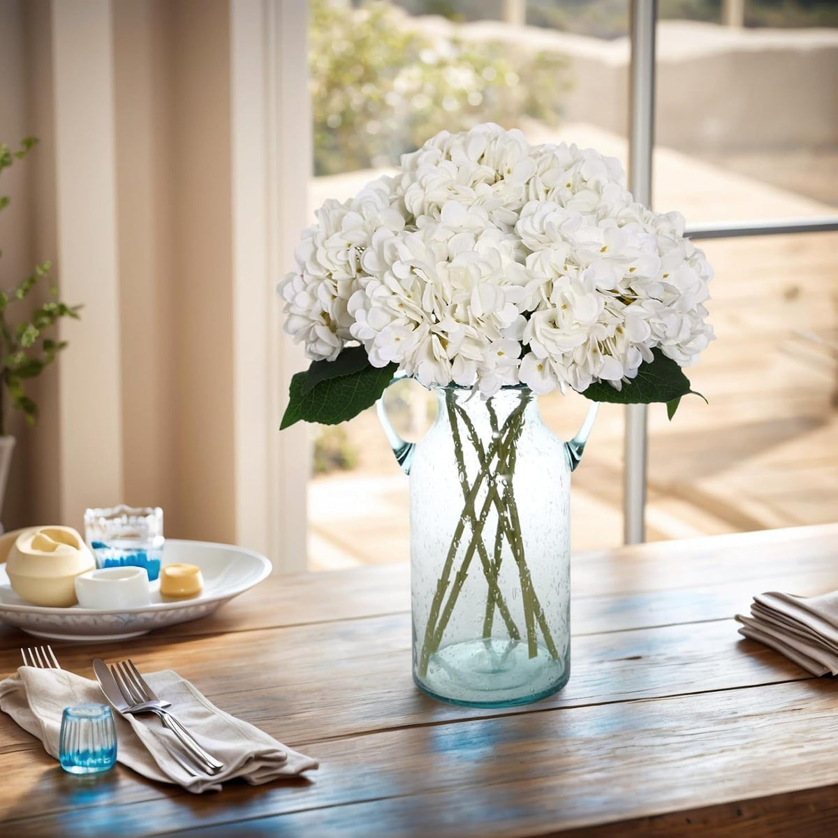 Artificial hydrangeas styled on a bright dining table