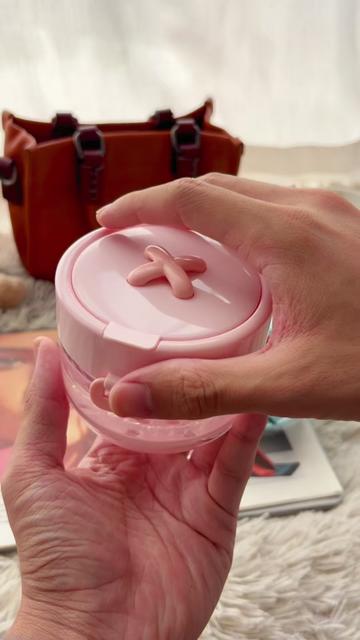 Pink cleaner case held beside a travel bag